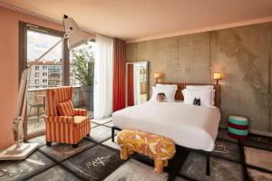 a bedroom with a large bed and a chair at Mama Shelter Lyon in Lyon +183 photos
