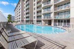 a swimming pool in front of a building at Island Princess 315 in Fort Walton Beach