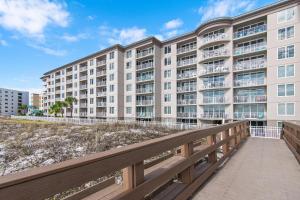 an apartment building with a boardwalk in front of a building at Island Princess 315 in Fort Walton Beach