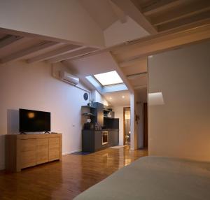 a large living room with a television and a couch at Le Mura Minicase int 4 in Castelfranco Veneto
