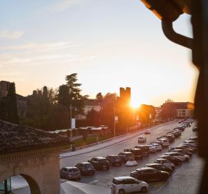 a long line of cars parked on a city street at Le Mura Minicase int 4 in Castelfranco Veneto +3 photos