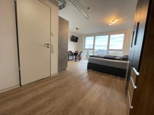 a large room with a bed and a large window at Apartmenthaus MK Immobilien in Stuttgart