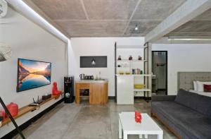 a living room with a couch and a table at Modern Apartment with Shared Pool - By the Beach in Seminyak +6 photos