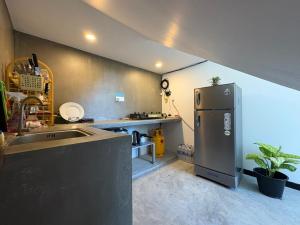 a kitchen with a stainless steel refrigerator and a sink at Minuda Villa in Kamburugamuwa