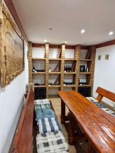 a room with a wooden table and shelves with wine bottles at Chata pod Kykulou in Oščadnica