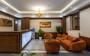 a lobby with chairs and a podium in a building at Zarafshon Garden Hotel in Bukhara