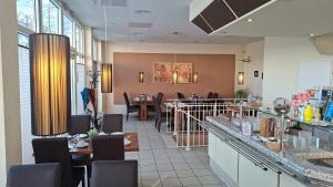 a restaurant with a dining room with tables and chairs at Hotel Prignitz in Wittenberge +1 photo