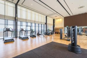 a gym with treadmills and exercise equipment in a building at Mossaz Suites by Mana Mana in Petaling Jaya