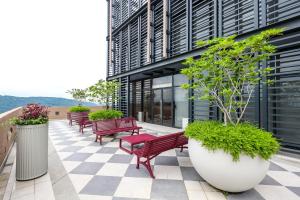 a row of red benches on a building patio at Mossaz Suites by Mana Mana in Petaling Jaya