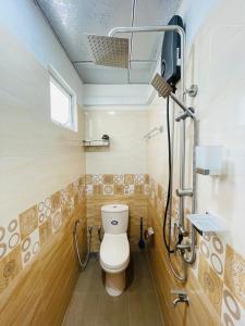a bathroom with a toilet and a shower at Anu Home Stay in Ahangama +15 photos