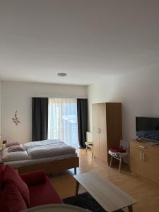 a bedroom with a bed and a living room at Lindenhof Deutsch in Bad Tatzmannsdorf