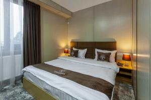 a hotel room with a large bed and a window at Zarafshon Garden Hotel in Bukhara +28 photos