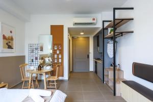 a living room with a table and a kitchen at Mossaz Suites by Mana Mana in Petaling Jaya