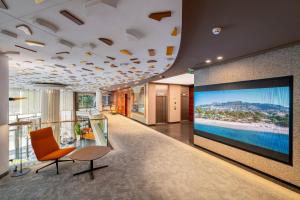 an office lobby with a large screen television on the wall at SH Valencia Palace in Valencia