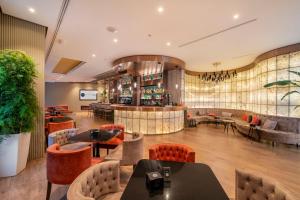 a restaurant with tables and chairs and a bar at SH Valencia Palace in Valencia