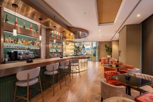 a restaurant with a bar with stools at SH Valencia Palace in Valencia