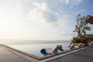 a swimming pool with a view of the ocean at Apec Mandala Chambay Mui Ne - Oceanic Studio in Mui Ne