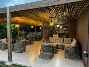 a patio with a couch and tables and chairs at Emangweni Guest House in Vryheid