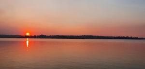 a sunset over a large body of water at Riverside Farm in eMalahleni
