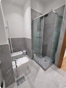 a bathroom with a glass shower and a toilet at Queen Barbara in Genoa