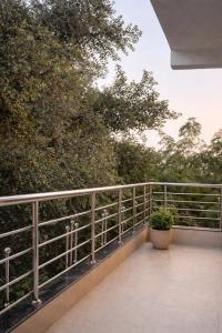 a balcony with a potted plant on a railing at Ekaay The Boutique Hotel in Kumārkara +5 photos