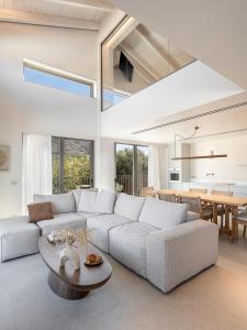 a living room with a couch and a table at Villa Villagio Rosso in Kókkinon Khoríon +54 photos
