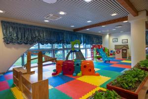 a childrens play room with a playground at Aparthotel Holiday in Bibione