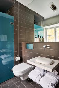 a bathroom with a toilet and a sink at Hotel Skeppsholmen, Stockholm, a Member of Design Hotels in Stockholm +43 photos