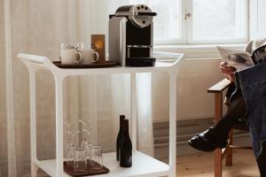 a white table with a coffee maker on top of it at Hotel Skeppsholmen, Stockholm, a Member of Design Hotels in Stockholm