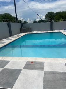 a large blue swimming pool with a tile floor at Marble Crest Guest House in Maun