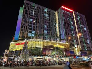 a large building with a christmas tree in front of it at Sophia Apartment S14-08 in Rạch Giá