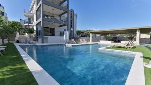 a large swimming pool in front of a building at Luxury Apartment Nala with shared pool in Sevid