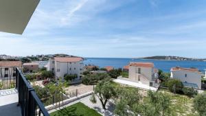 a view of the ocean from the balcony of a house at Luxury Apartment Nala with shared pool in Sevid