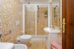 a bathroom with a shower and a toilet and a sink at The Stone House Historic Center in Grotte di Castro +3 photos