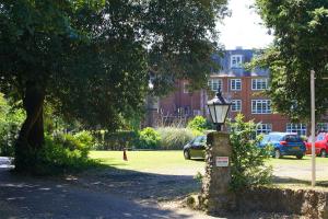 a street light in a park in front of a building at Best Western Abbots Barton Hotel in Canterbury