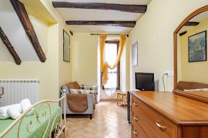 a living room with a bed and a tv at The Stone House Historic Center in Grotte di Castro