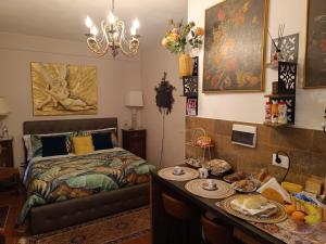 a bedroom with a bed and a table with food on it at B & V Home in Montemerano