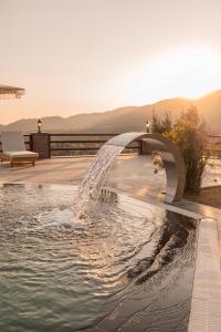 a swimming pool with a water fountain at Kaira Kazdaglari in Edremit +5 photos
