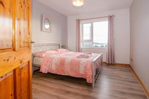 a bedroom with a bed and a window at Sea View Heights in Rathmullan +29 photos