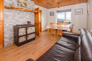 a living room with a couch and a table at Sea View Heights in Rathmullan