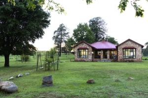 a stone house in the middle of a field at Elgin Farm Dullstroom in Dullstroom
