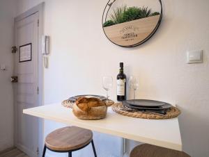 a table with a bottle of wine and two glasses at Vidéoprojecteur - Tout à pied - Centre - Balcon in Montpellier +12 photos