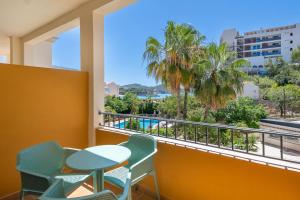 a balcony with a table and chairs and a view at FLOR los Almendros Hotel in Paguera