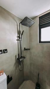 a shower stall in a bathroom with a window at Testudo Madiha in Matara +22 photos