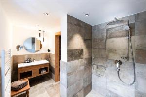 a bathroom with a shower and a sink at Hotel Grünerhof in Obergurgl