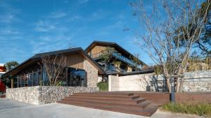 a house with a staircase in front of it at cloud retreat·half an ocean hotel in Zhoushan