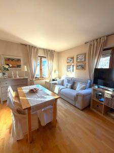a living room with a couch and a table at Bormio Alpine Home in Bormio