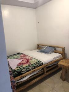 a bedroom with a wooden bed in a room at NYUNGWE ECOLODGE - Gisakura in Nyamasheke