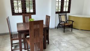 a dining room with a wooden table and chairs at Hikka Residence 98 in Hikkaduwa +11 photos