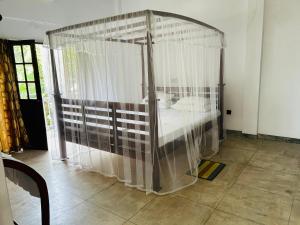 a bedroom with a bed in a canopy at Hikka Residence 98 in Hikkaduwa